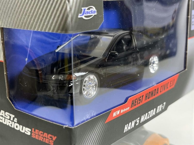 a black toy car in a box
