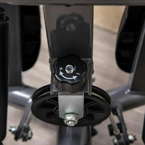 Grey stepper resistance control knob near the pedal base with mounting plate