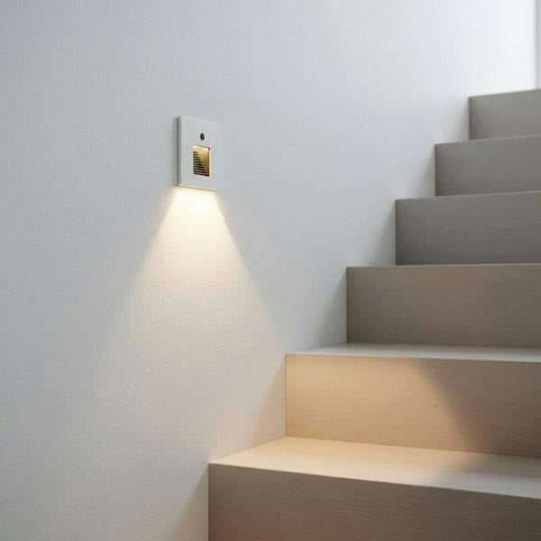 white LED stair light with motion sensor fitted in the wall next to some stairs indoors