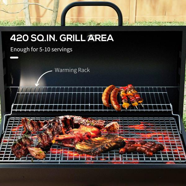 Black charcoal BBQ grill interior with warming rack above the main cooking grate