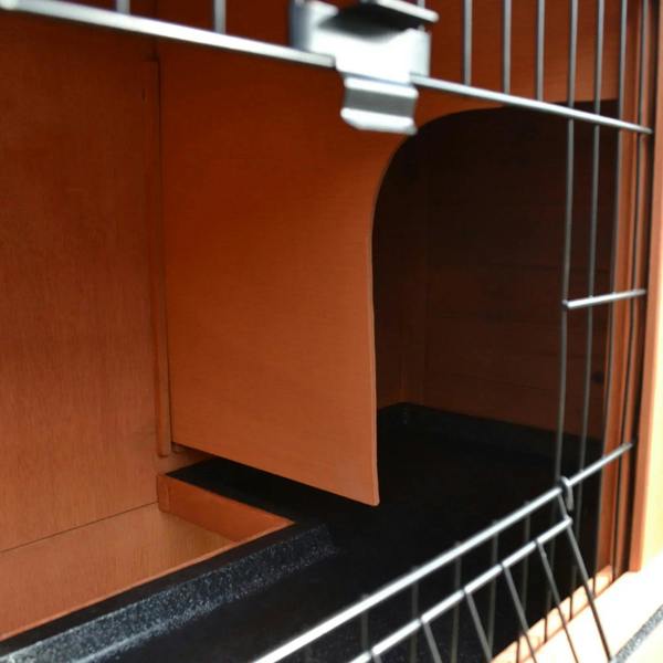 Close-up inside 2-tier rabbit hutch showing black base and wire front partition near door
