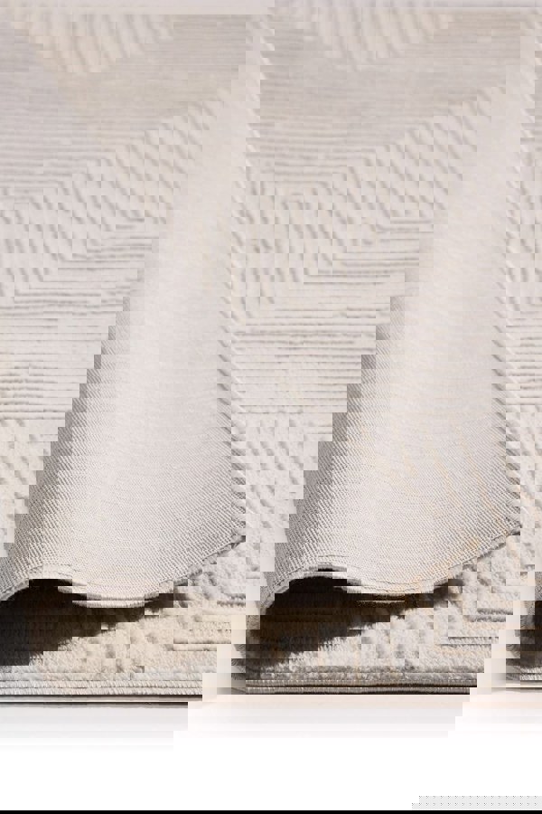 Abstract geometric rug in cream shades, showcasing the texture and softness of its surface, ideal for modern interiors.