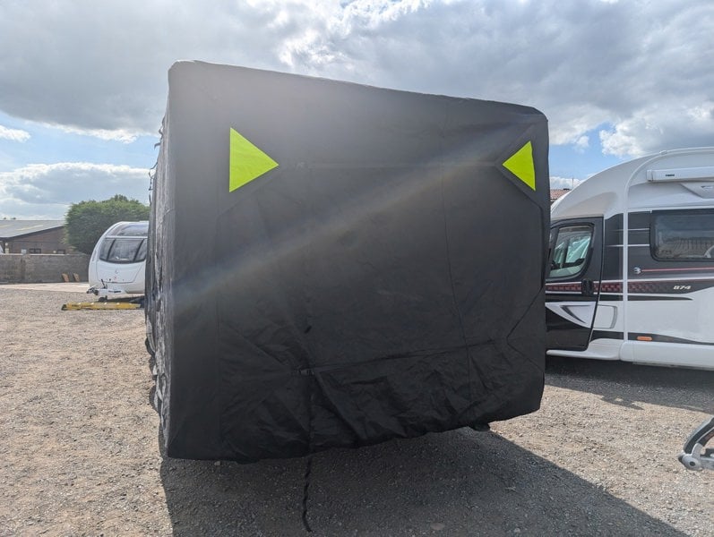 An image of the back of the Breathable Waterproof 4Ply Caravan Cover with Free Hitch Cover Black from OLPRO showing the reflective corners.