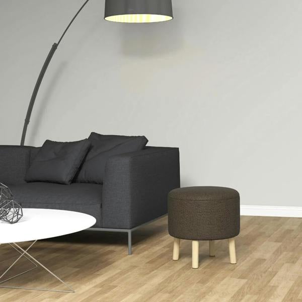 Brown round storage ottoman stool with padded seat and light wood legs in room
