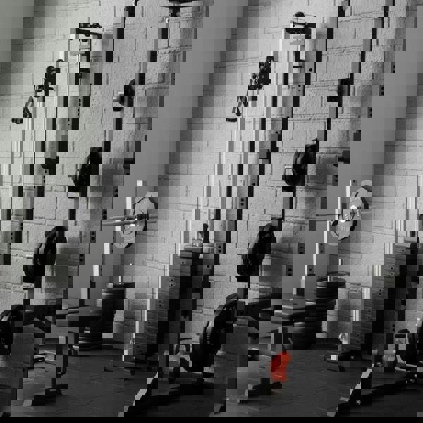 Wall mounted cable pulley machine with adjustable weights, sleek silver frame, and ergonomic handles in a modern gym setting