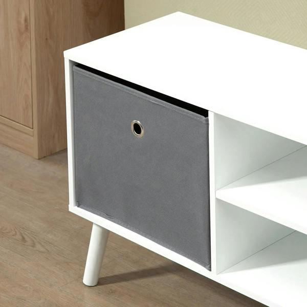 Grey fabric drawer front with metal ring pull on a white TV cabinet frame