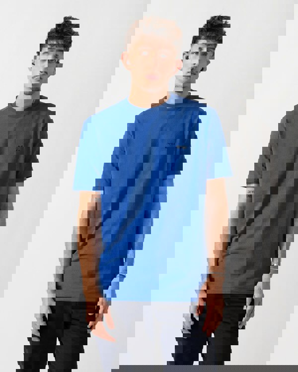 Model wearing a BOSS Green Tee Mens Stretch Cotton T-Shirt with Contrast Logo in Medium Blue