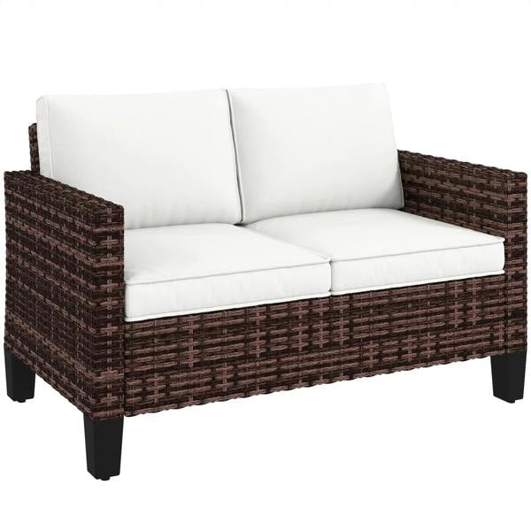 Brown rattan outdoor sofa with white cushions, two seats, wide armrests and dark legs