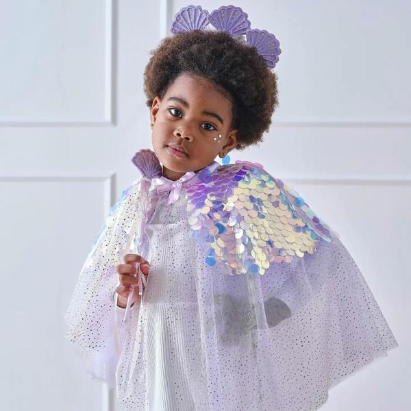 Young girl with an afro wearing a luxury purple mermaid princess costume cape with iridescent scales, matching wand, and seashell crown headband.