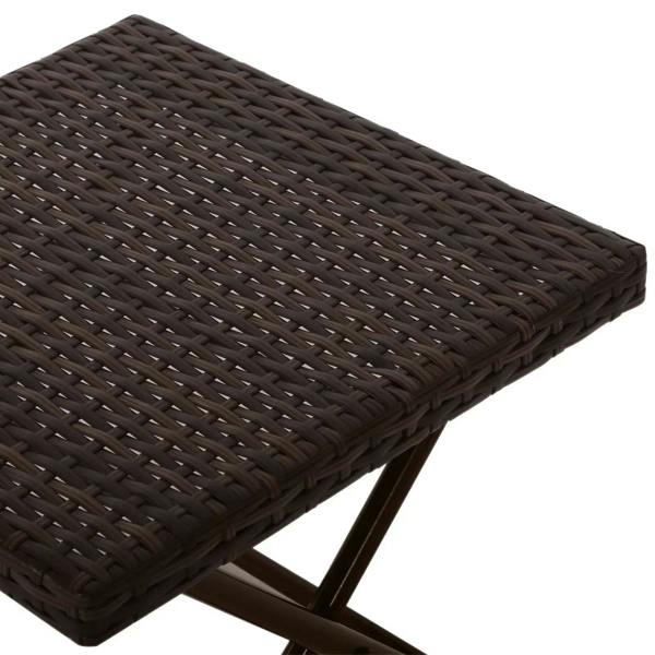Close-up of brown woven rattan tabletop with folding X-frame base