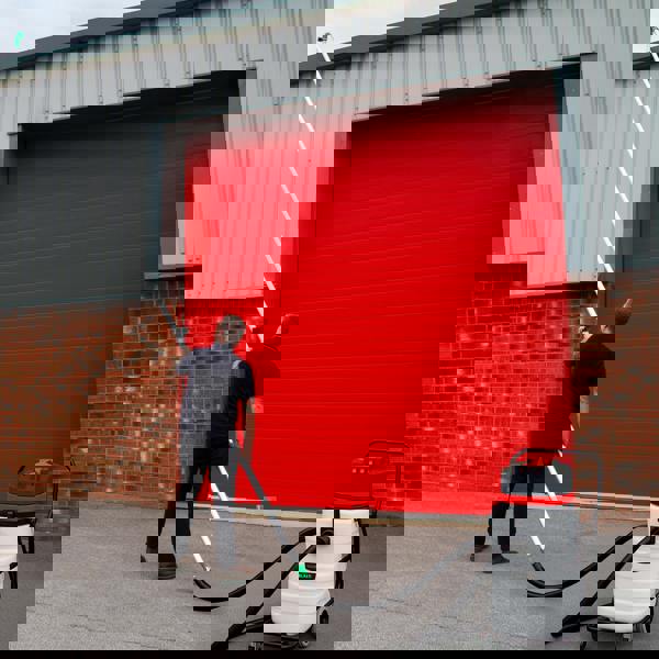 90L wet and dry vacuum with gutter vacuum poles, man using pole to clean a red garage door, durable white and black design