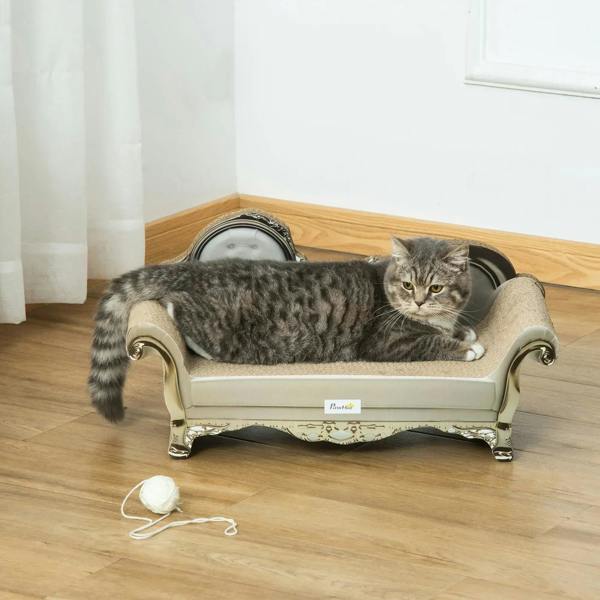 Beige cat sofa bed with scratching pad, grey tabby cat lying down with toy nearby