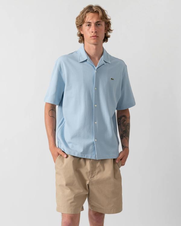 model wearing a Lacoste Relaxed Fit Short Sleeved Mens Piqué Shirt in Chambray HBA