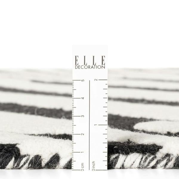 Textured black and white fabric with a ruler for scale on a white background, featuring the 'ELLE Decoration' brand.