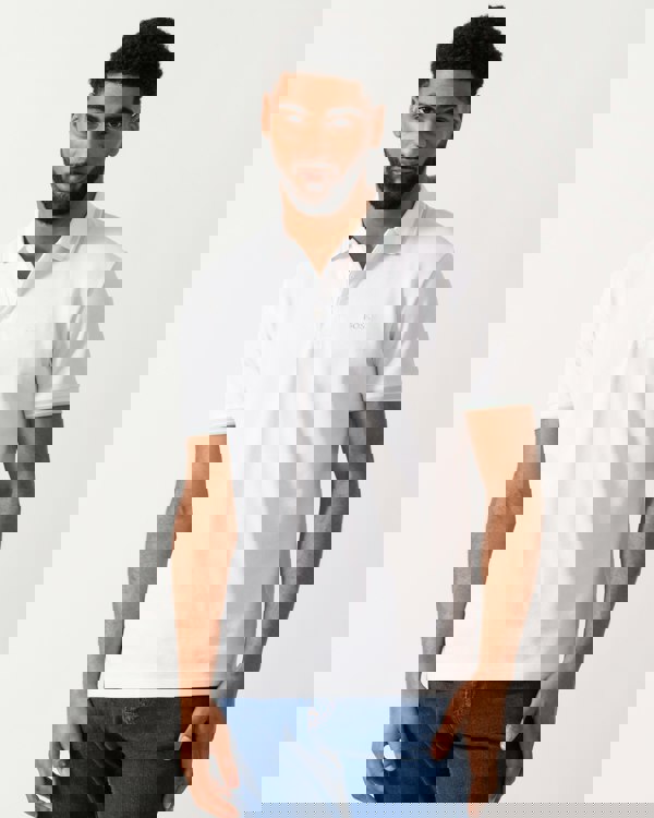 Model wearing a BOSS Green Paddy Mens Cotton-Piqué Polo Shirt with Contrast Logo in Open White