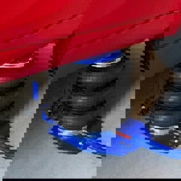 Air Bag Jack 3.5T with long lever handle, featuring three black rubber air bags, sturdy blue base, and red vehicle underneath