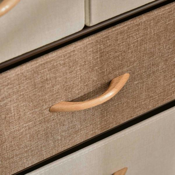Close-up of a fabric drawer front with wooden pull handle on a steel-framed dresser tower