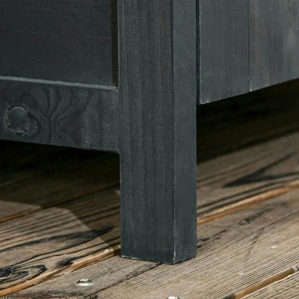 Grey wooden shed corner post with base edge on deck boards