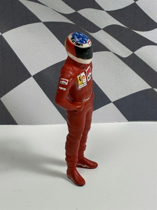 a toy figure of a race car driver