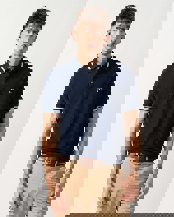 Model wearing a Lacoste Contrast Collar Pique Mens Regular Fit Polo Shirt in Navy Blue