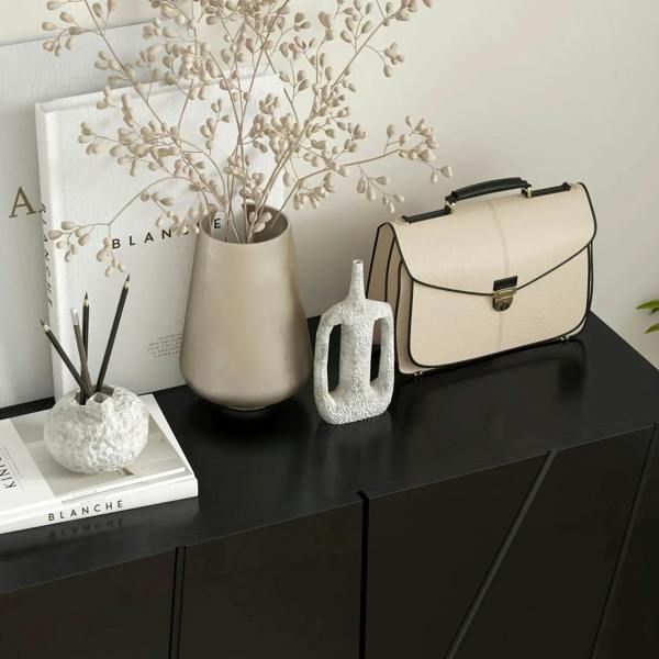 Black high-gloss shoe cabinet with closed doors and a flat top surface