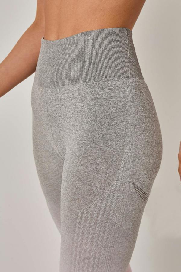 Gray leggings worn by a person on a plain background