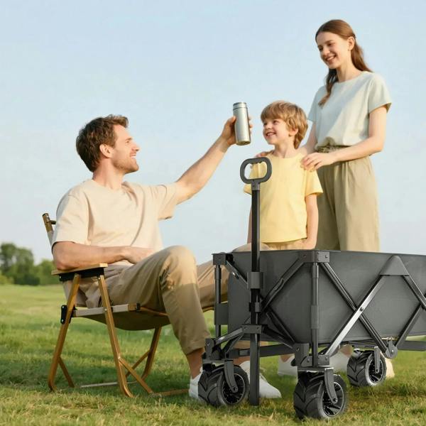 Dark grey folding cargo wagon trailer with telescopic pull handle and oversized all-terrain wheels