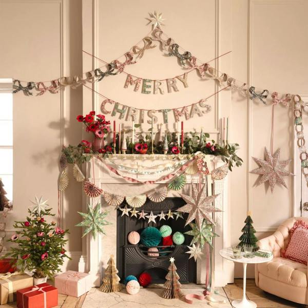Luxurious Liberty print Christmas bow garland draped across a grand white fireplace mantelpiece surrounded by festive decorations.