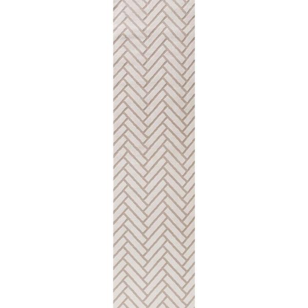 Beige and white geometric patterned rug on a plain background