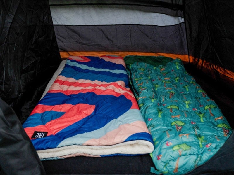 Kids Patterned Sleeping Bag by OLPRO pictured along side the Blanko Outdoor Fleece lined Blanket.