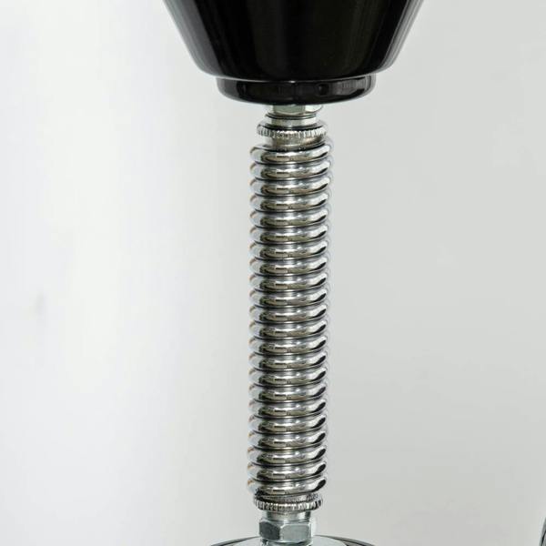 Close-up of metal spring and connector on a black boxing stand