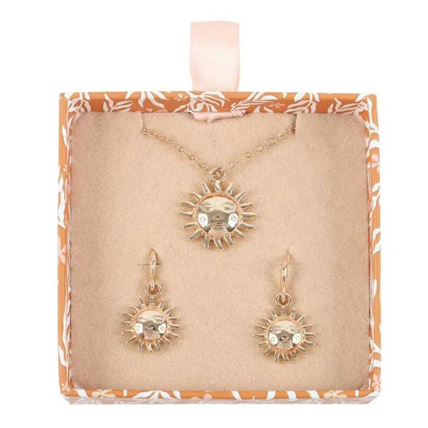 Gold-tone sun pendant necklace and matching sun charm drop earrings on display card