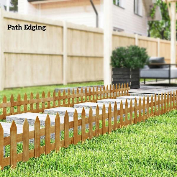 Brown wooden picket fence path edging with pointed posts along grass verge