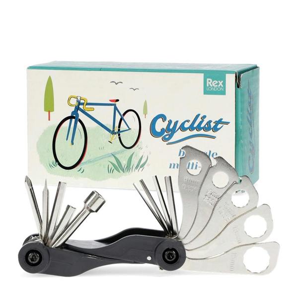 A black multi-tool with various silver metal attachments fanned out, positioned in front of a blue and white retro-style cardboard box featuring a vintage bicycle illustration.