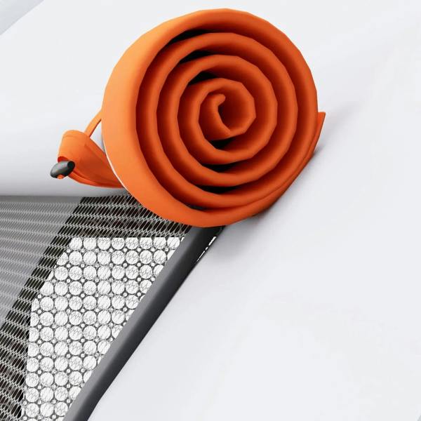 Orange rolled tent base mat with textured circular grip pattern