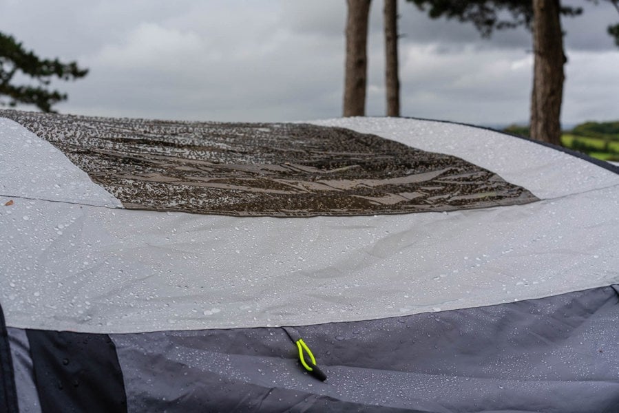 A closeup of the OLPRO Blakedown Breeze 4 Berth Inflatable Tent skylight with beads of rain on it.