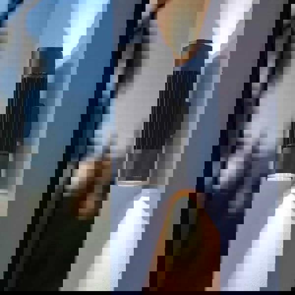 large exterior wall light mounted on a white column outside a building