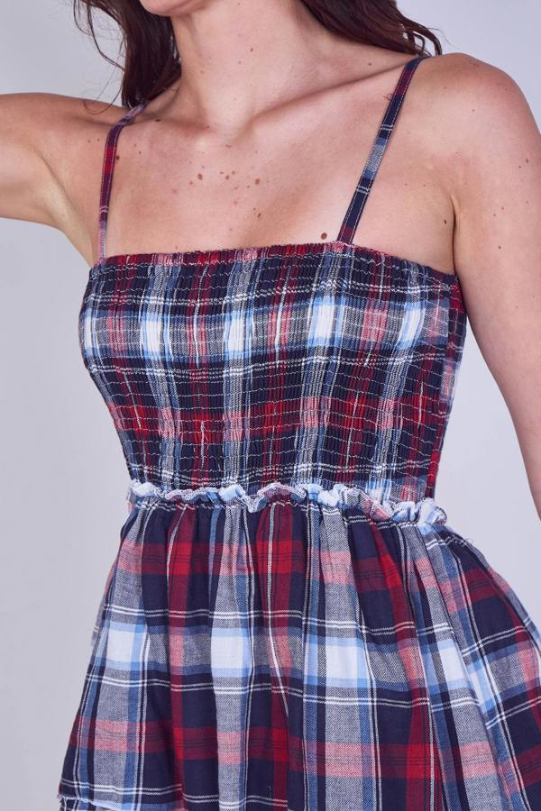 Plaid dress with thin straps on a plain background