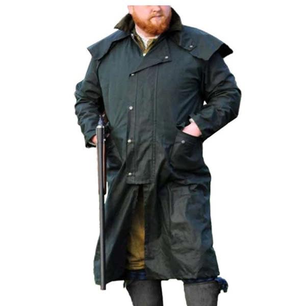 Shooter wearing Classic Wax Stockman coat in open countryside for protection during wet field days