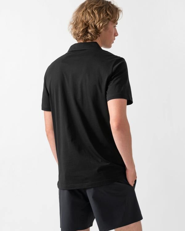back shot of a model wearing an Emporio Armani Mens Beach Polo with Eagle Logo in Black