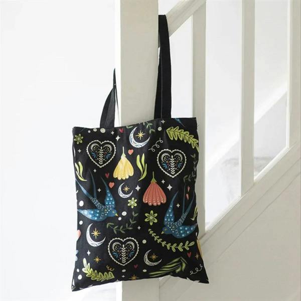 Black polcotton tote bag with colorful floral and bird pattern
