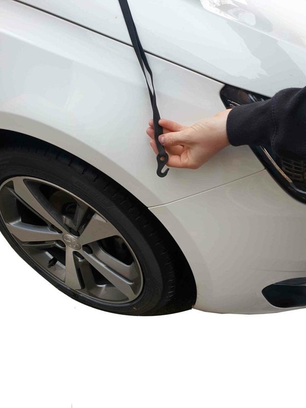 The Nylon Car Top Cover Extra Large by OLPRO on a white family car depicting the hooks that are used to fasten the cover on the vehicle.