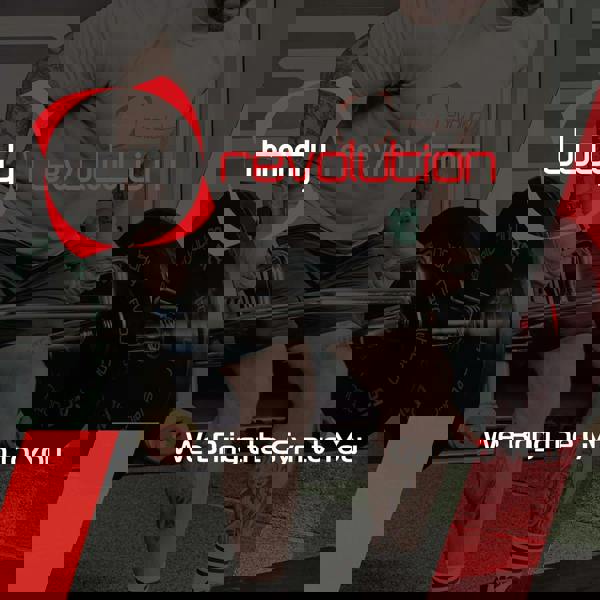 Muscular individual lifting a Body Revolution 4ft barbell bar with black weight plates, showcasing strength training in a gym setting