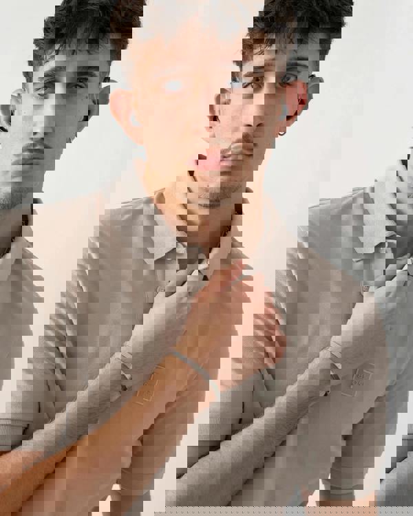 close up shot of a model wearing a BOSS Orange Passenger Mens Stretch-Cotton Slim-Fit Polo Shirt with Logo Patch in Open Grey 070