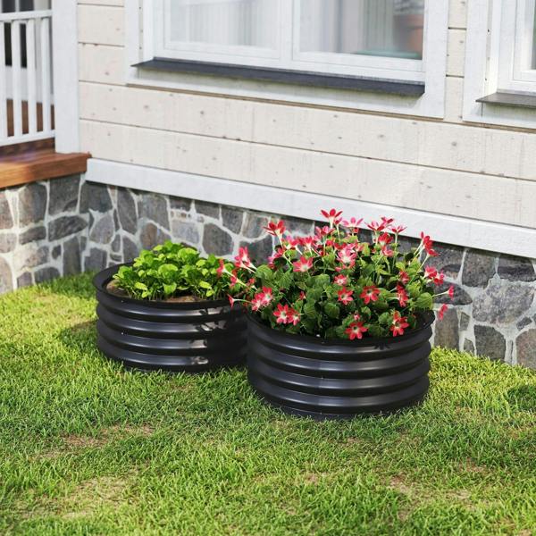 Set of 2 dark grey raised garden beds with green herbs and pink flowers on lawn