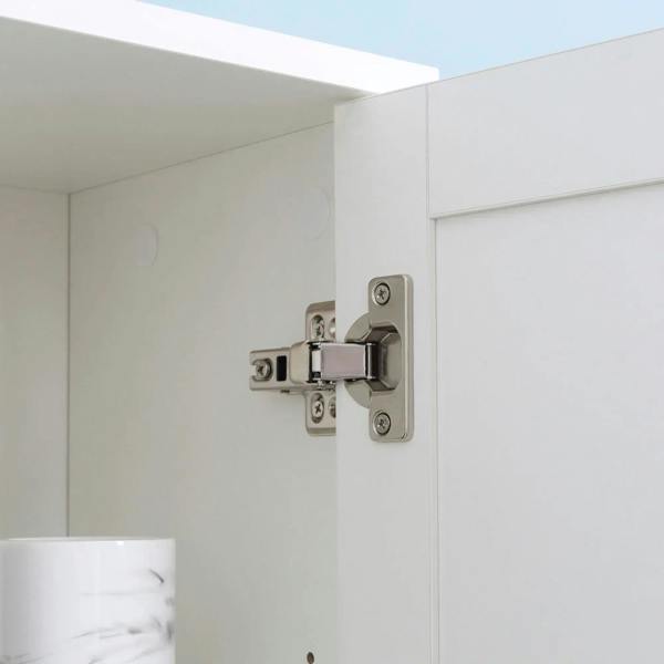 White cabinet door hinge and hardware on tall bathroom storage unit