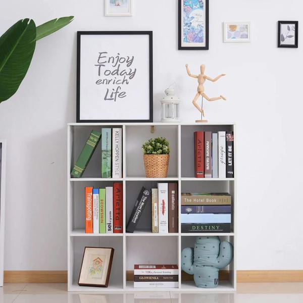 White square-cube storage shelf with open compartments, styled with books and a small plant.