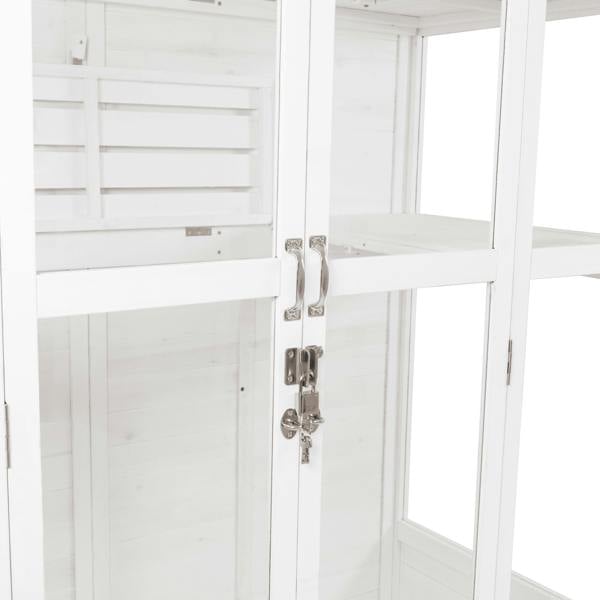 Elegant Victorian greenhouse in white wood, featuring glass panels, silver handles, and a secure lock for plant protection