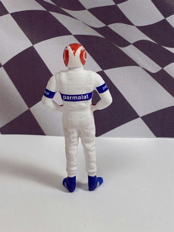 a toy figure of a race car driver