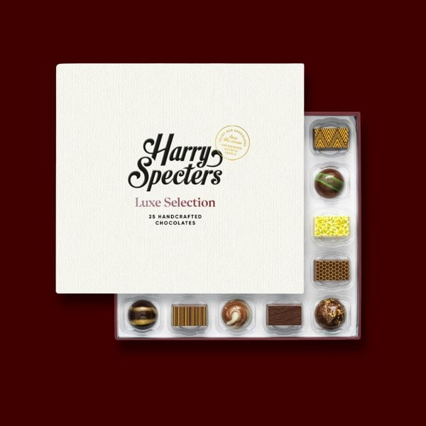 A box of 25 premium artisan chocolates partially covered by a lid